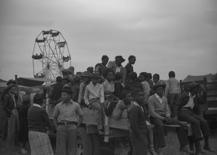 The crowd gathered on a truck bed as the day ends